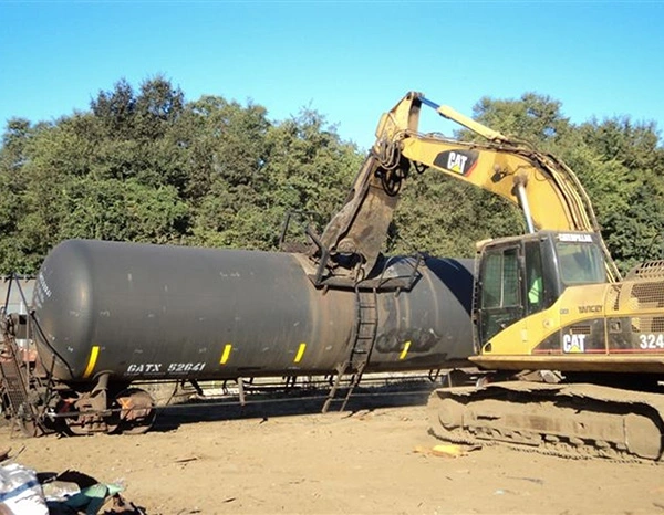 Excavator dismantling railcar for recycling recovery