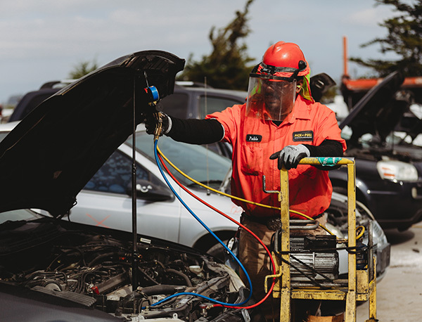 Technician performing certified vehicle parts recycling service