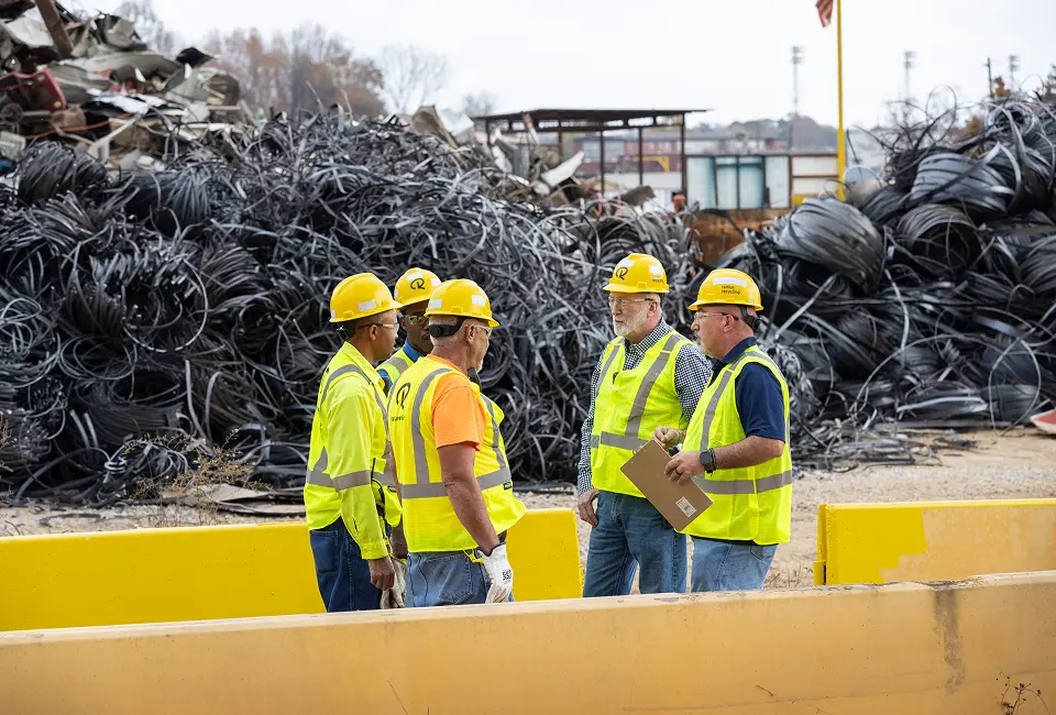 Contractors discussing construction and demolition scrap metal recycling at a Radius Recycling yard