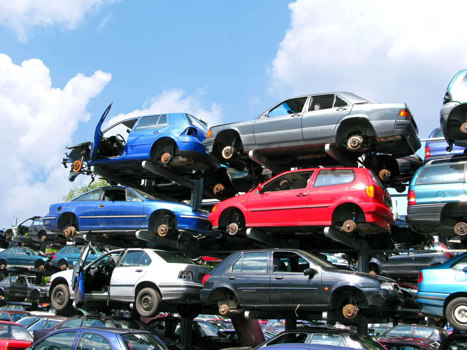 Stacked junk cars at a scrap yard ready for recycling and metal recovery