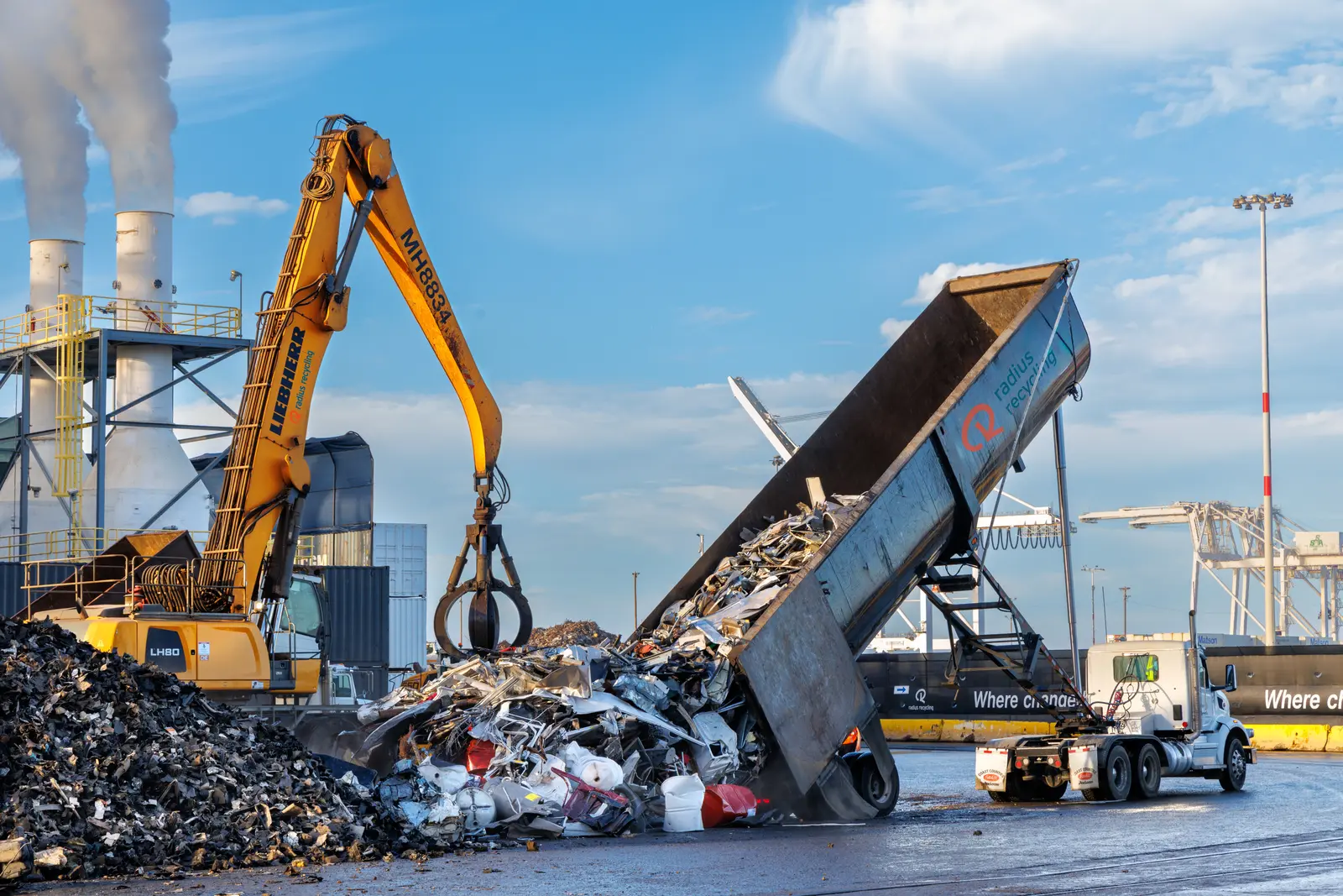 Scrap metal being unloaded at industrial recycling site